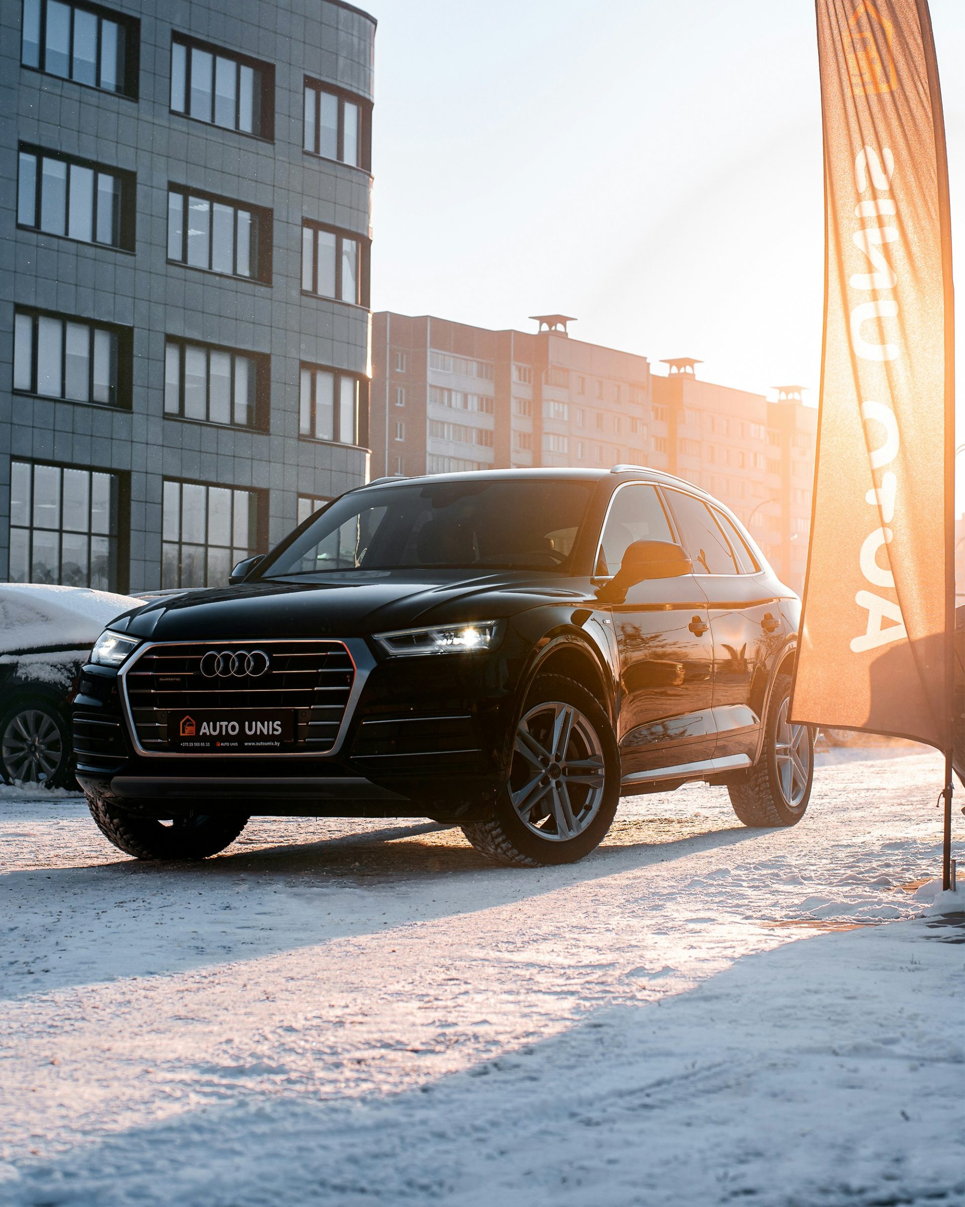 a black car parked in front of a building